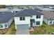 Beautiful two-story home with a well-manicured lawn, gray accents, and a spacious two-car garage in a friendly neighborhood at 2208 Darley Oak Way, North Port, FL 34289