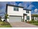 Charming two-story home featuring a gray two-car garage, landscaped yard, and a covered front entryway at 2208 Darley Oak Way, North Port, FL 34289