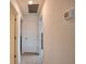 Clean hallway featuring neutral carpet, white walls, a white door and a thermostat at 2208 Darley Oak Way, North Port, FL 34289