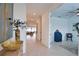 Inviting hallway features neutral tile flooring and stylish decor, leading to the home's living areas and a separate office space at 2208 Darley Oak Way, North Port, FL 34289