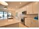 Contemporary kitchen with sleek appliances, a central island, and elegant finishes, creating a perfect space for culinary exploration at 2208 Darley Oak Way, North Port, FL 34289