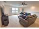 Cozy upstairs living area with plush seating, a ceiling fan, and natural light at 2208 Darley Oak Way, North Port, FL 34289