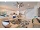 Spacious living room with a ceiling fan and a view of the dining room and kitchen at 2208 Darley Oak Way, North Port, FL 34289