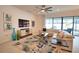 Comfortable living room featuring a large window with views of the outdoor lanai and pool area at 2208 Darley Oak Way, North Port, FL 34289