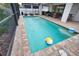 Sparkling pool with brick pavers, beach balls, and relaxing lounge chairs in screened in lanai area at 2208 Darley Oak Way, North Port, FL 34289