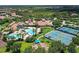 Aerial view of community amenities including pool, tennis courts, and common areas at 2444 Daisy Dr, North Port, FL 34289