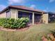 Manicured backyard showing screened in porch/patio area, grass, and landscaping at 2444 Daisy Dr, North Port, FL 34289