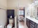 Modern bathroom showing toilet, sink, and vanity, with view into the main bedroom at 2444 Daisy Dr, North Port, FL 34289
