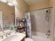 Clean bathroom with a shower/tub, black shelving, a white countertop and bright vanity lighting at 2444 Daisy Dr, North Port, FL 34289
