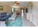 Open-concept living room with tile floors, neutral colors, and a ceiling fan at 2444 Daisy Dr, North Port, FL 34289