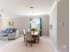 Open concept living and dining room with tile floors and neutral decor at 2444 Daisy Dr, North Port, FL 34289