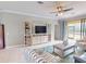 Bright living room features neutral decor, ceiling fan, and an open floor plan at 2444 Daisy Dr, North Port, FL 34289