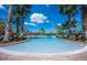 Resort-style pool with lounge chairs and landscaping at 2444 Daisy Dr, North Port, FL 34289