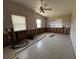 Spacious living room showing damage remediation, tiled floors, and a ceiling fan at 3120 Wisteria Pl, Punta Gorda, FL 33950