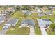 Beautiful aerial view of a single-story house with manicured lawns, mature trees, and a paved driveway at 73 Santarem Cir, Punta Gorda, FL 33983