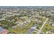 Expansive aerial view of a residential community showcasing well-maintained homes, green lawns, and tree-lined streets at 73 Santarem Cir, Punta Gorda, FL 33983