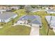Aerial view of a well-maintained single Gathering home with mature landscaping and an attached garage at 73 Santarem Cir, Punta Gorda, FL 33983
