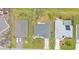 Aerial view of home in a residential neighborhood with a well-manicured lawn and long driveway at 73 Santarem Cir, Punta Gorda, FL 33983
