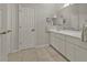 Bright bathroom featuring double sinks, tile floors, and neutral decor at 73 Santarem Cir, Punta Gorda, FL 33983