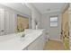 Bright bathroom features white vanity, large mirror, neutral walls, and shower-tub combination at 73 Santarem Cir, Punta Gorda, FL 33983