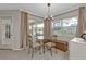 Charming breakfast nook featuring a glass table, decorative chairs, and bright natural light from surrounding windows at 73 Santarem Cir, Punta Gorda, FL 33983