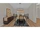 Well-lit dining room with hardwood floors, buffet, and a modern chandelier at 73 Santarem Cir, Punta Gorda, FL 33983