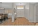 Bright entryway with hardwood floors, modern chandelier, and double front doors at 73 Santarem Cir, Punta Gorda, FL 33983