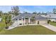 Charming single-story home with manicured lawn, stone accents, and attached two-car garage at 73 Santarem Cir, Punta Gorda, FL 33983