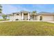 Inviting single-story home with manicured lawn, stone accents, and two-car garage at 73 Santarem Cir, Punta Gorda, FL 33983