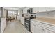 Well-equipped kitchen featuring stainless steel appliances, white cabinets, and ample counter space for cooking at 73 Santarem Cir, Punta Gorda, FL 33983