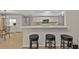 Open-concept kitchen with bar seating, and white cabinetry at 73 Santarem Cir, Punta Gorda, FL 33983