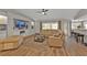Comfortable living room with a large television, plush seating, and wood floors, perfect for relaxation and entertainment at 73 Santarem Cir, Punta Gorda, FL 33983