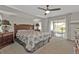 Comfortable main bedroom with soft carpet and a sliding glass door to the lanai at 73 Santarem Cir, Punta Gorda, FL 33983