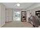 Carpeted office with shelves, sliding doors, and windows offering natural light and backyard views at 73 Santarem Cir, Punta Gorda, FL 33983