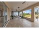 Spacious outdoor patio ideal for relaxing or entertaining, featuring tiled flooring and views of the lush backyard at 73 Santarem Cir, Punta Gorda, FL 33983