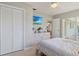 Bright bedroom featuring closet, dresser, doorway to exterior at 890 Silver Springs Nw Ter, Port Charlotte, FL 33948