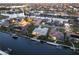 An aerial view showcasing a waterfront community with homes, canals, and docks at 936 Lassino Ct, Punta Gorda, FL 33950