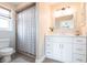 This bathroom features a single vanity with drawers and a shower with a neutral colored curtain at 936 Lassino Ct, Punta Gorda, FL 33950
