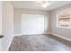 Bright bedroom with wood-look flooring, a window, and a large closet at 936 Lassino Ct, Punta Gorda, FL 33950