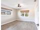 Cozy bedroom featuring wood-look floors and natural light from two windows with woven shades at 936 Lassino Ct, Punta Gorda, FL 33950