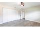 This bedroom features light walls, light wood floors, a ceiling fan, and a large closet at 936 Lassino Ct, Punta Gorda, FL 33950