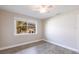 Bright bedroom featuring stylish wood-look floors, a modern ceiling fan, and a window at 936 Lassino Ct, Punta Gorda, FL 33950