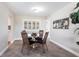 This dining room features tile floors, a wood table with 4 chairs, and a chandelier at 936 Lassino Ct, Punta Gorda, FL 33950