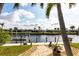 Private waterfront dock featuring boatlift access with a paved path through the yard at 936 Lassino Ct, Punta Gorda, FL 33950