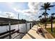 Waterfront dock featuring a boat lift and sunny views, perfect for boating and enjoying waterfront living at 936 Lassino Ct, Punta Gorda, FL 33950