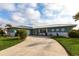 Charming single-story home with a well-maintained lawn and a driveway leading to the garage at 936 Lassino Ct, Punta Gorda, FL 33950
