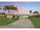 Beautiful single-story home with a curved driveway and well-manicured front lawn at 936 Lassino Ct, Punta Gorda, FL 33950