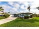 Charming single-Gathering home showcasing a well-manicured lawn, lovely landscaping, and an attached garage at 936 Lassino Ct, Punta Gorda, FL 33950