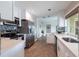 Well-lit kitchen with stainless appliances, white cabinets, and modern countertops at 936 Lassino Ct, Punta Gorda, FL 33950