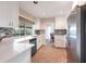 Kitchen with stainless steel appliances, white cabinetry and modern backsplash at 936 Lassino Ct, Punta Gorda, FL 33950